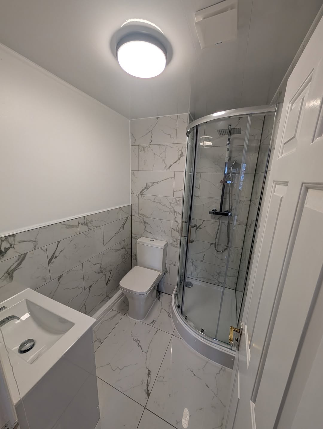 Marble bathroom installation with walk-in shower completed by Cotswold Maintenance Group in Gloucester